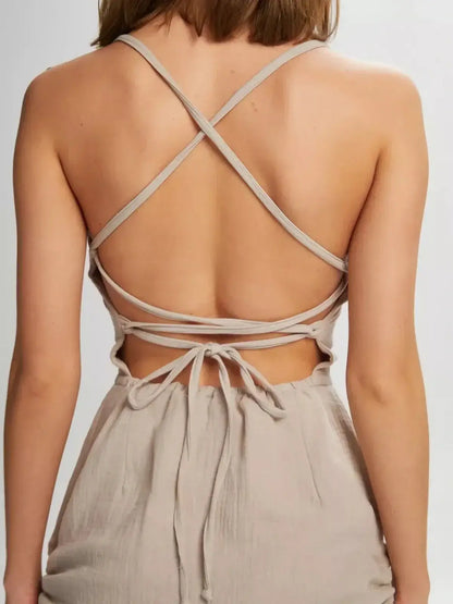 Back view of a stylish mini dress with lace-up open back and adjustable straps, perfect for summer occasions.