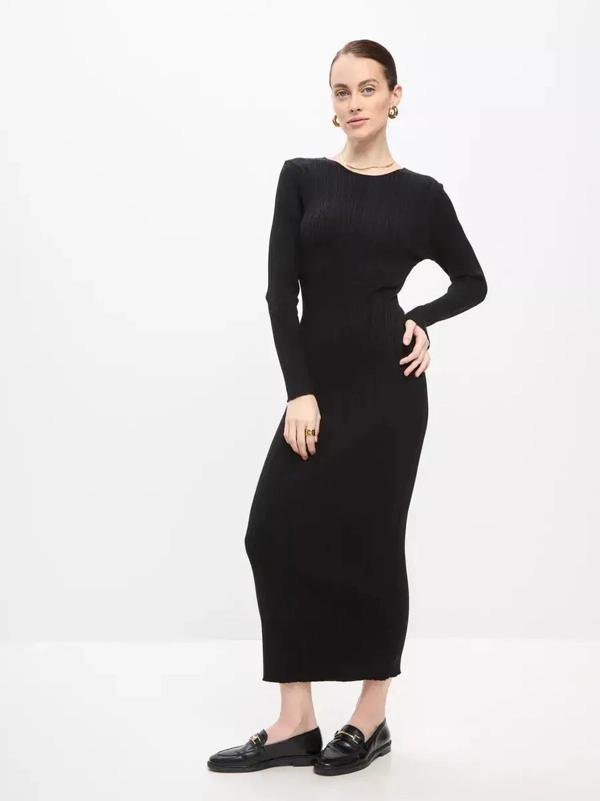 Elegant black sculpted rib maxi dress on model, showcasing a streamlined silhouette for versatile styling.