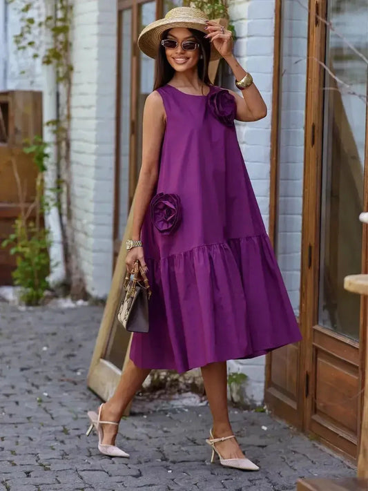 Model showcasing a vibrant plum Midi Dress Bloom Vignette with sculptural rosettes and a tiered hem, perfect summer attire.