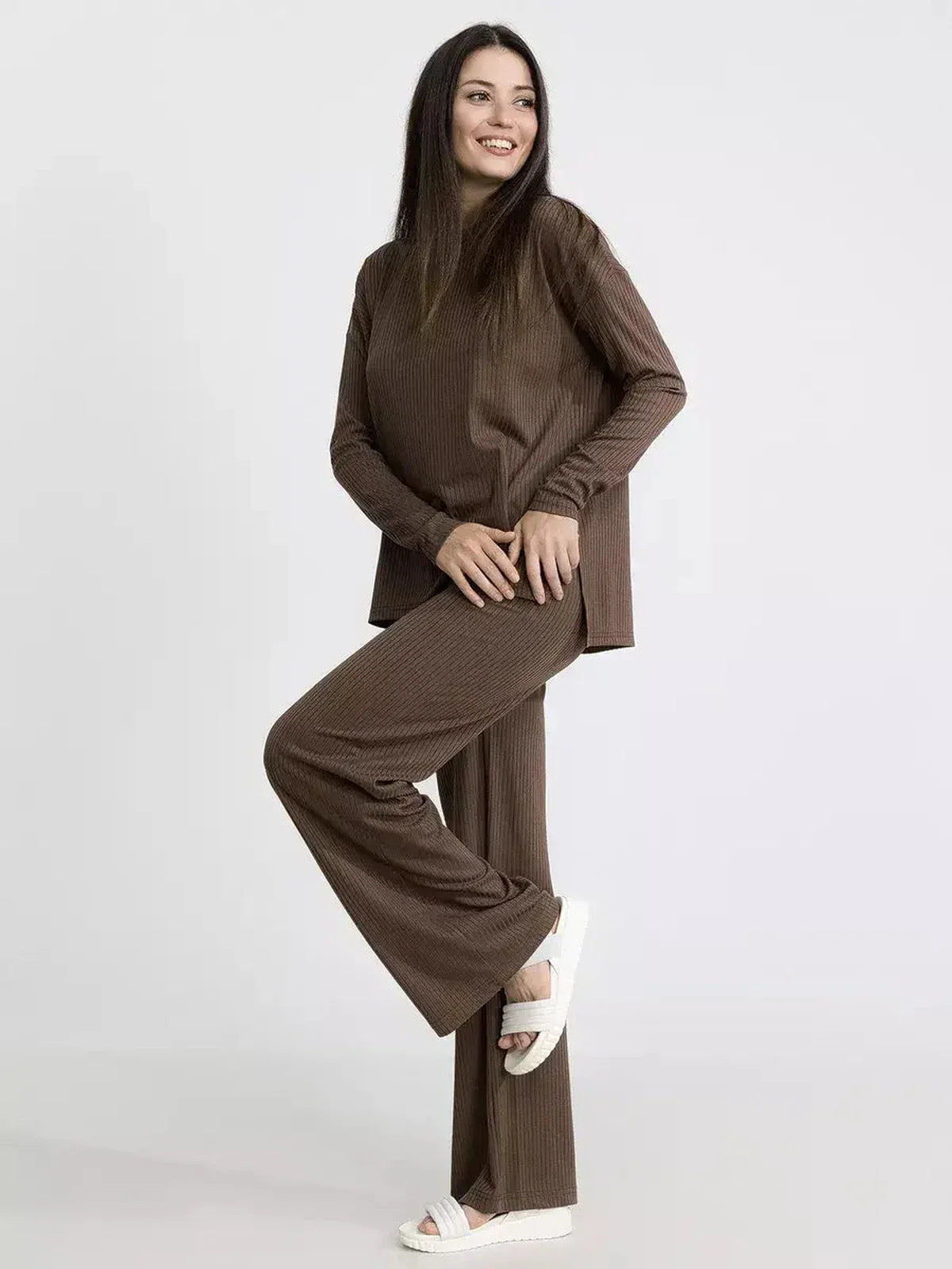 Model showcasing a soft ribbed knit lounge set in brown, emphasizing oversized comfort and minimalist style.