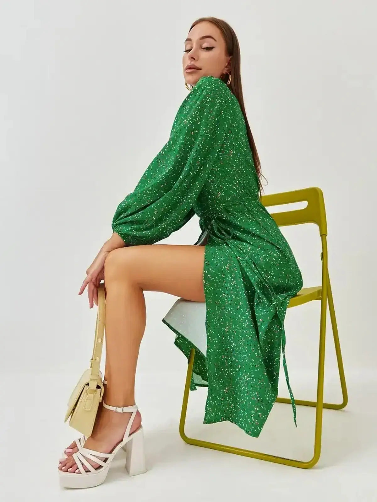 Elegant green midi dress featuring a wrap design and speckled print, perfect for summer and special occasions.