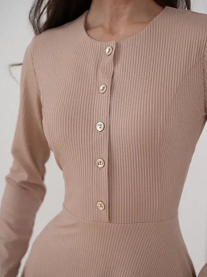 Beige ribbed knit midi dress with a round neckline and gold-tone button accents, perfect for elegant everyday wear.
