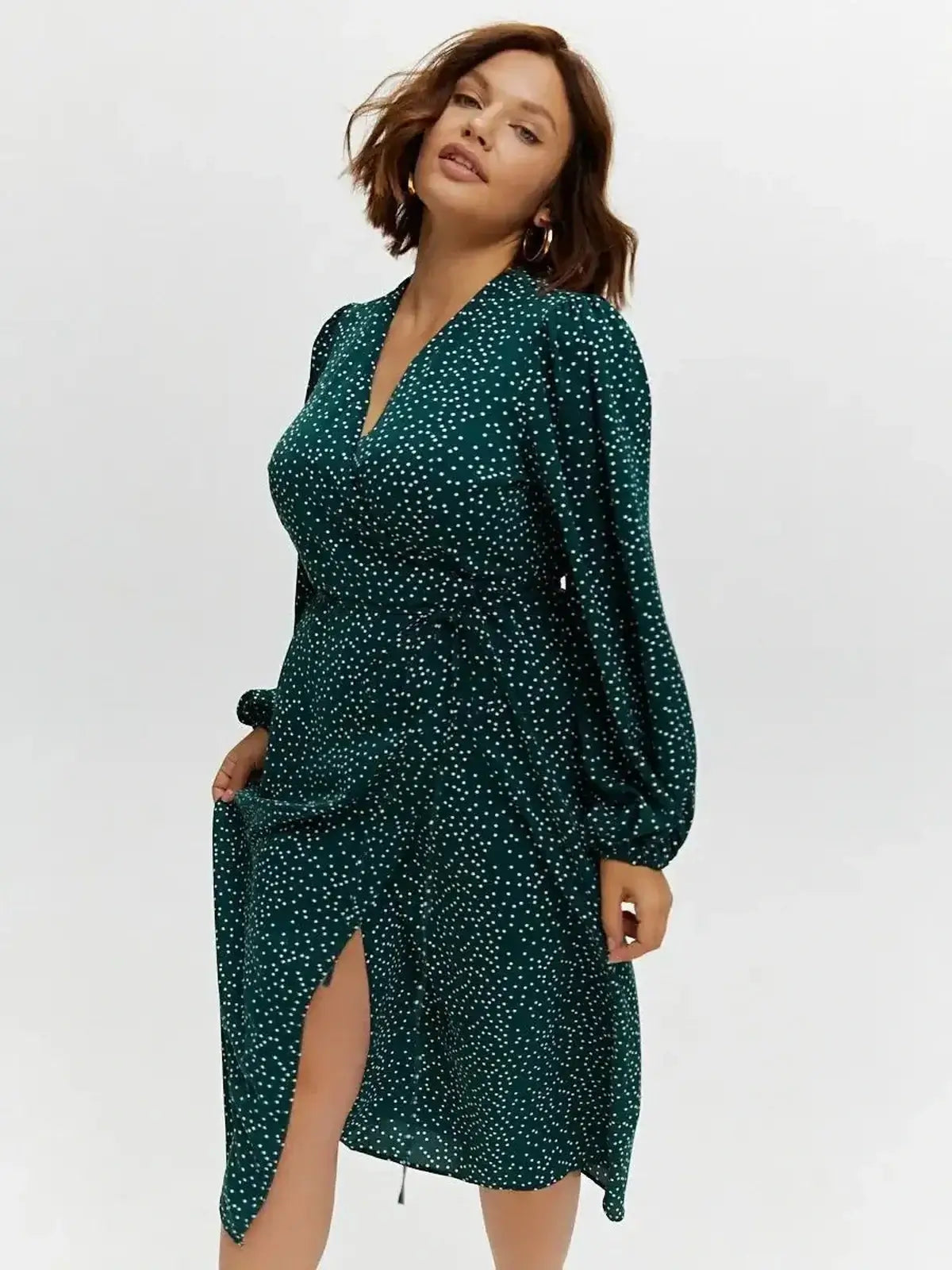 Celeste Midi Dress in green with polka dots, featuring a wrap style and deep V-neck, perfect for weddings and special events.