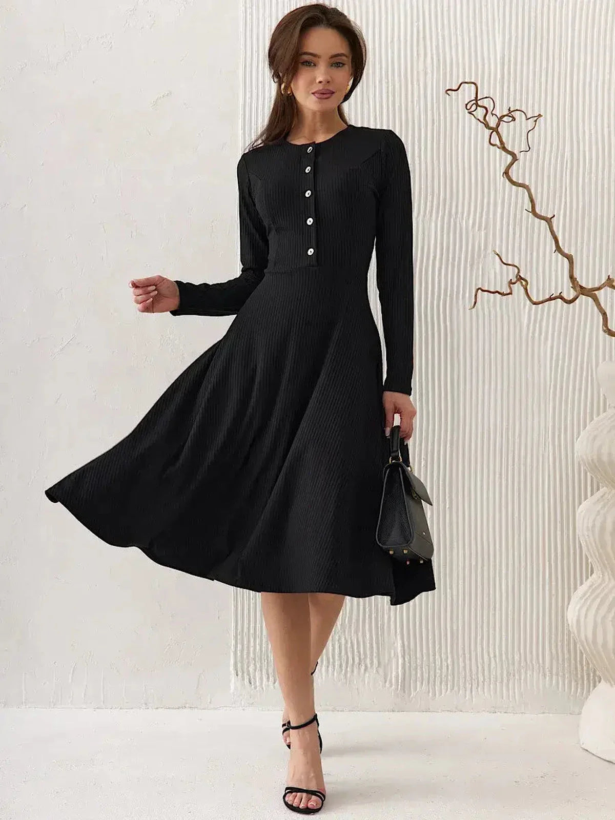 Elegant black midi dress with ribbed texture, tailored bodice, and vintage-inspired buttons, perfect for weddings and formal events.