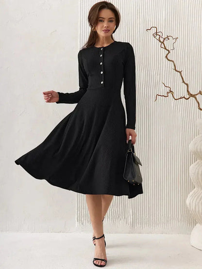 Elegant black midi dress with ribbed texture, tailored bodice, and vintage-inspired buttons, perfect for weddings and formal events.