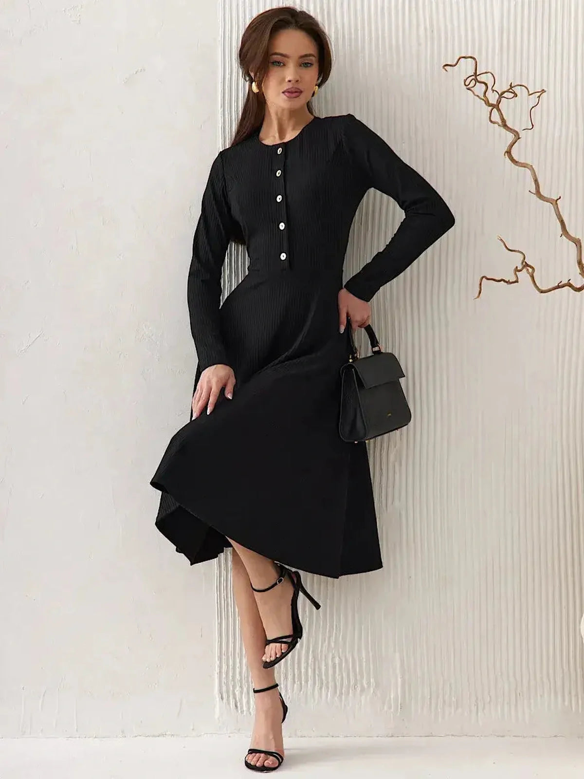 Serene Grace Midi Dress in black ribbed fabric, showcasing a tailored fit with decorative buttons and a flared skirt.