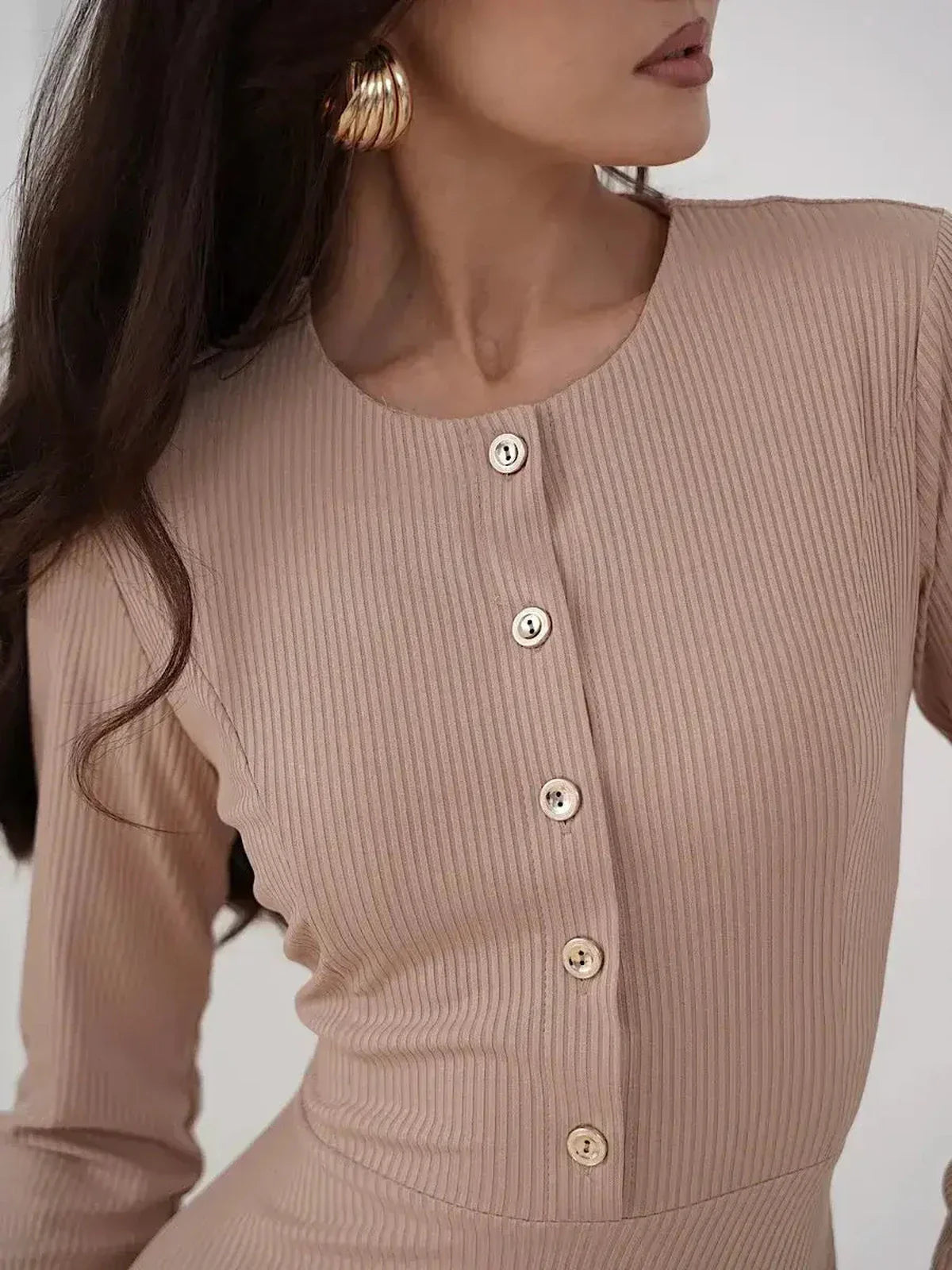 Close-up of the Sculpted Ease Midi Dress in ribbed knit with buttons, highlighting its elegant beige color and tailored fit.