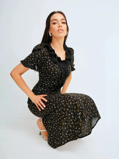 Elegant black midi dress with dainty floral prints and ruffled details, perfect for weddings or formal occasions.