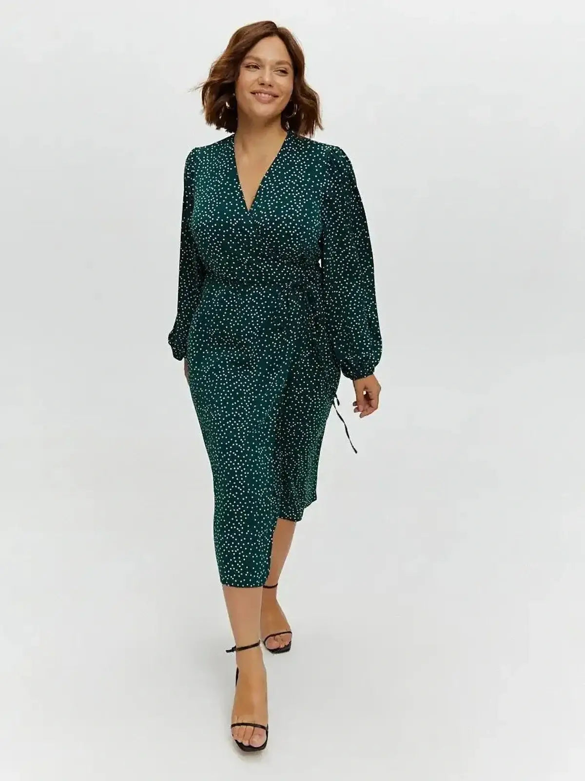 Celeste Midi Dress in deep green with polka dots, featuring a wrap style silhouette and long sleeves, perfect for various occasions.