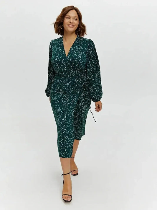 Celeste Midi Dress in deep green with polka dots, featuring a wrap style silhouette and long sleeves, perfect for various occasions.
