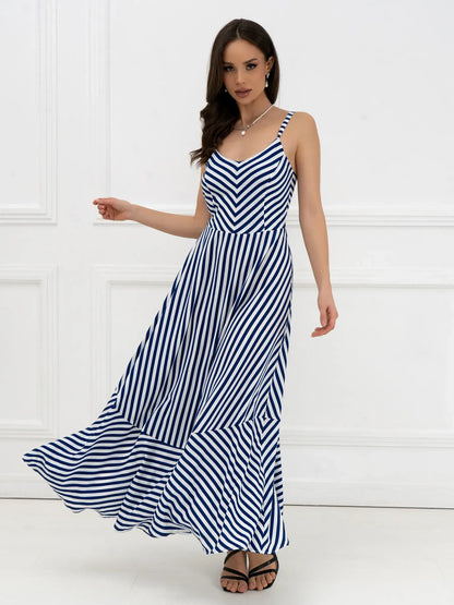 Marina Stripe Maxi Dress with bold stripes and open-back bow detail, perfect for summer events and weddings.