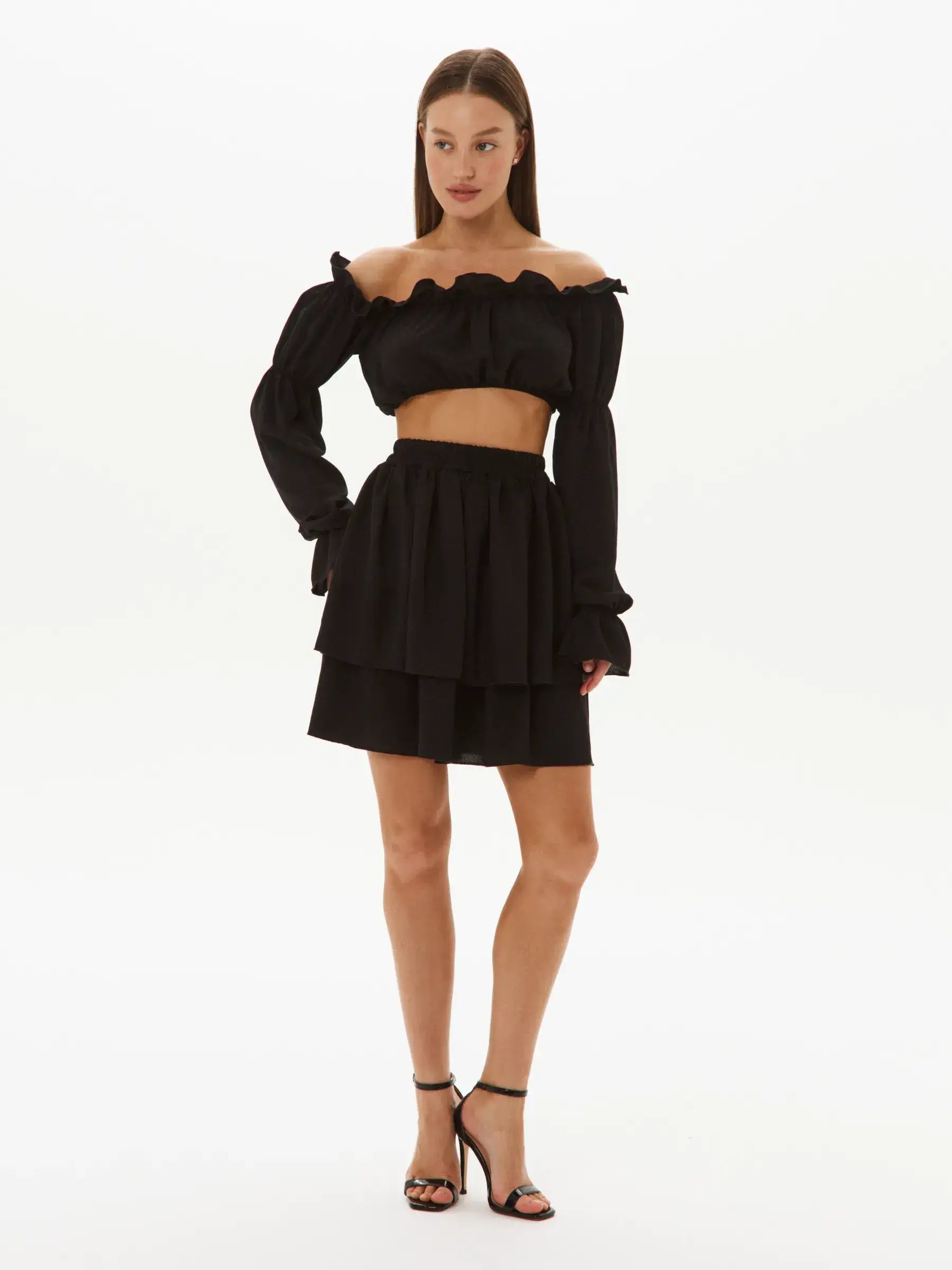 Stylish Ruffle Muse Set featuring an off-shoulder top and tiered mini skirt, perfect for summer events and weddings.