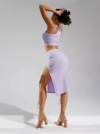 Stylish woman showcasing the Lilac Cutout Set with unique crop top and high-waisted skirt featuring a side slit.