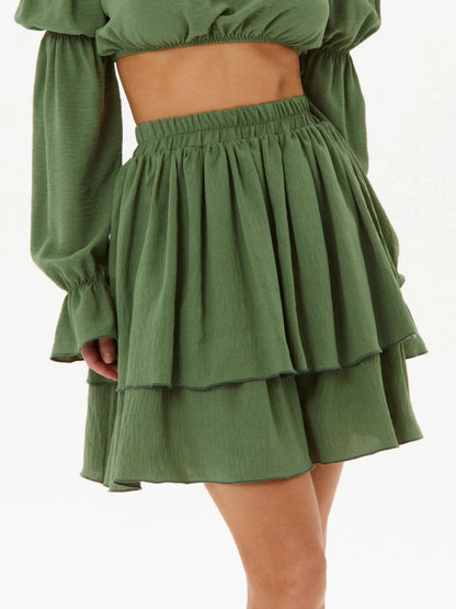Tiered ruffle skirt in khaki fabric, features a gathered waist and flowing layers for a chic look.