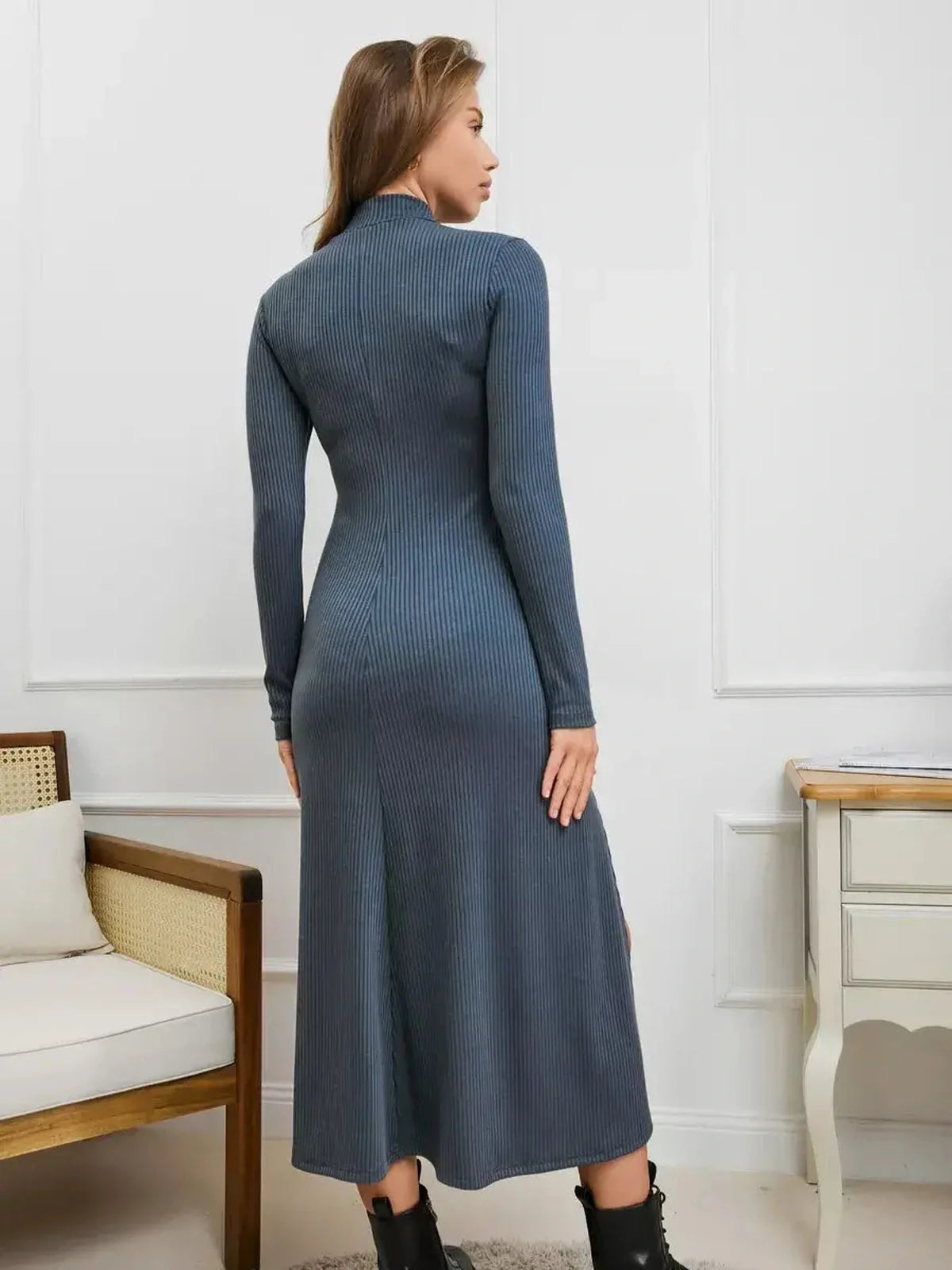 Back view of a woman in a Midnight Slit Midi Dress showcasing ribbed knit and dramatic side slits, ideal for evening occasions.