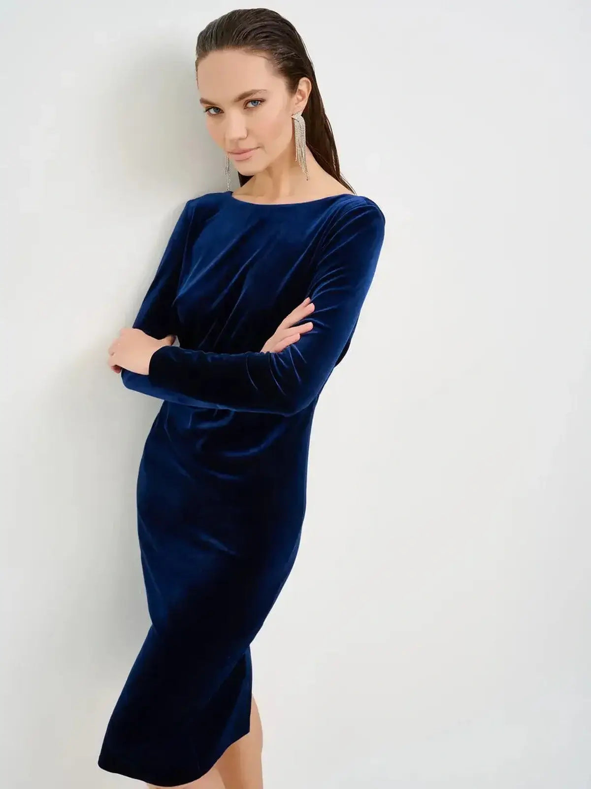 Model wearing a sleek Velvet Obsidian Midi Dress in deep navy, showcasing its elegant silhouette and luxurious texture.