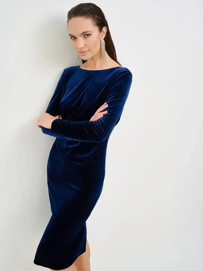 Model wearing a sleek Velvet Obsidian Midi Dress in deep navy, showcasing its elegant silhouette and luxurious texture.