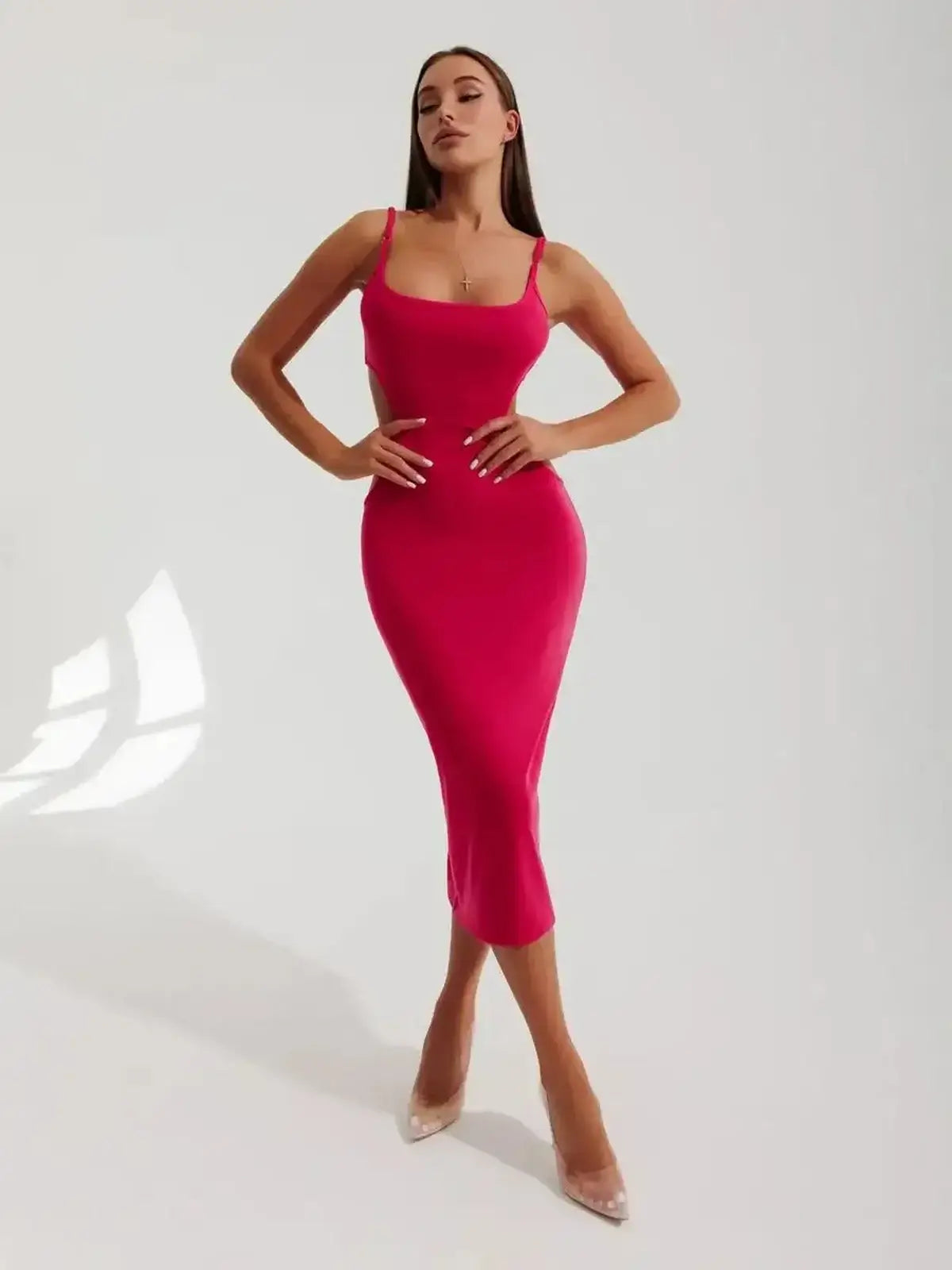 Sculpt Midi Dress in vibrant pink, featuring contour cutouts and a figure-hugging fit, ideal for summer events or special occasions.