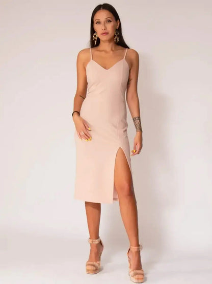 Woman wearing Serene Charm Midi Dress with elegant straps, thigh-high slit, and minimalist design in soft beige tone.