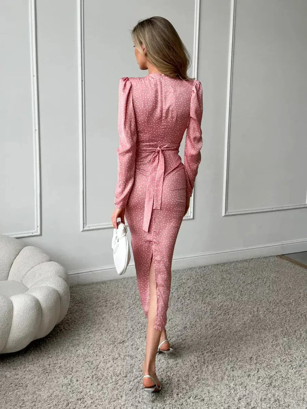 Back view of Grace Drape Midi Dress in pink polka dots, featuring elegant ruched detailing and a flattering silhouette.