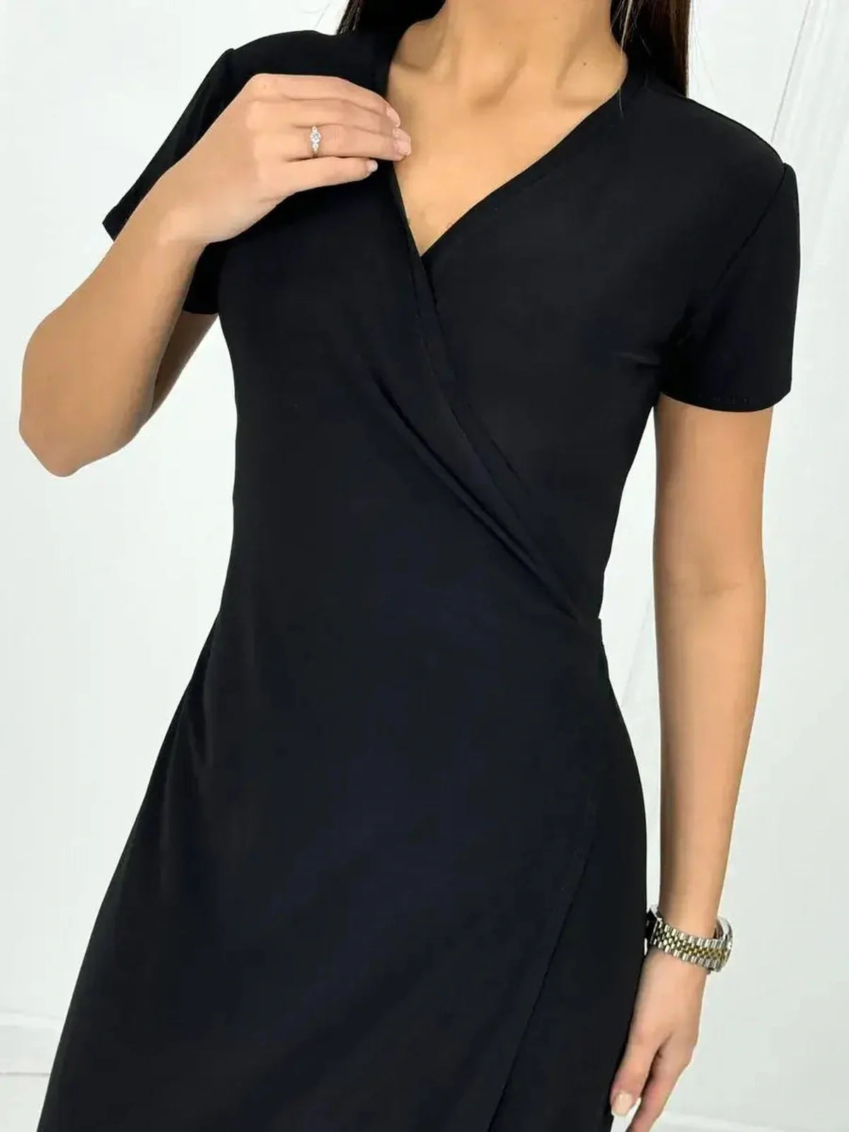 Elegant black maxi dress with a flattering wrap silhouette, perfect for summer events and special occasions.