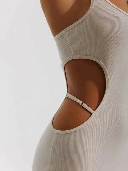 Close-up of Midi Dress Seraphine showcasing sculptural side cutouts in beige ribbed knit, designed for elegant allure.
