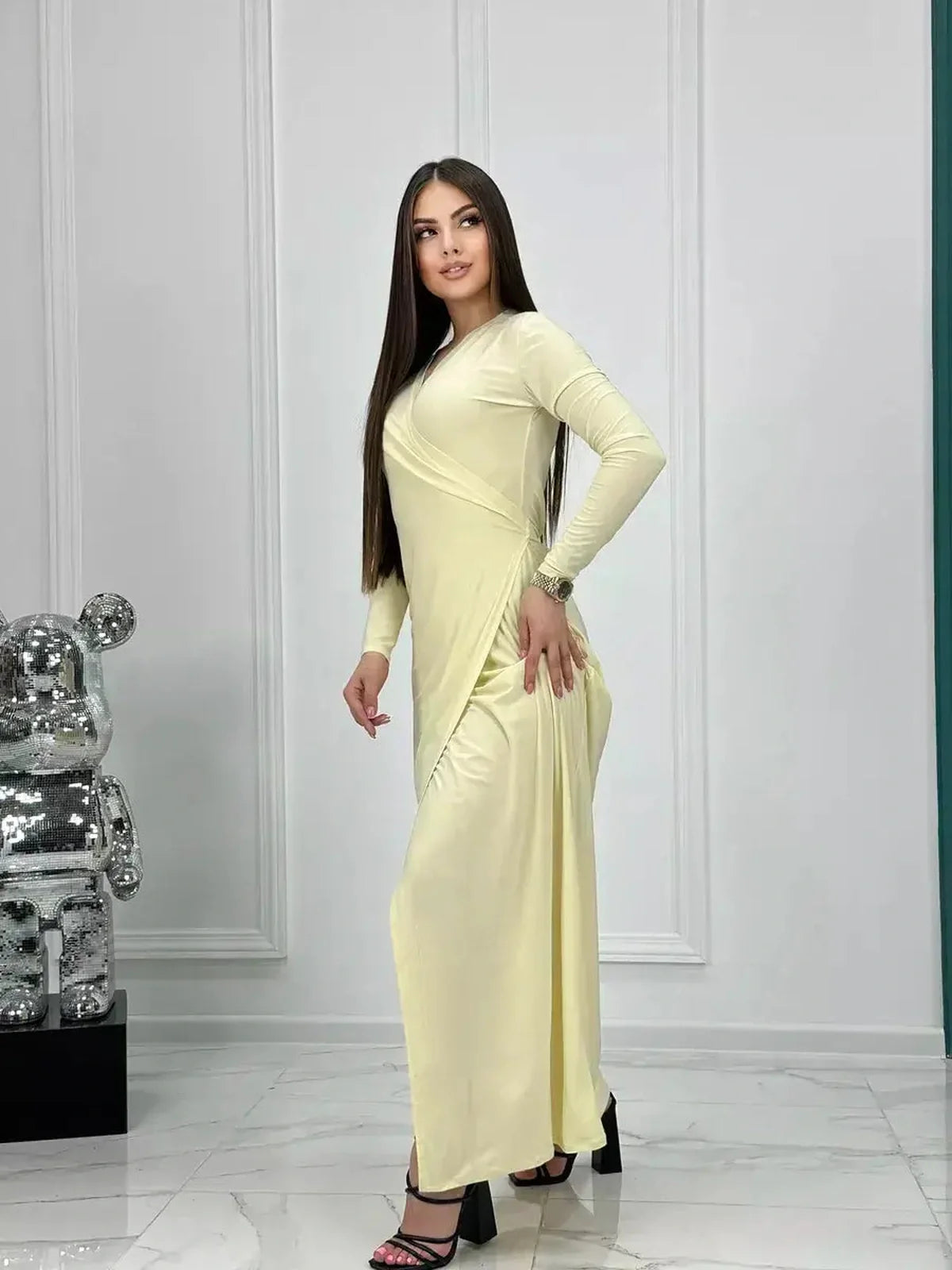 Model showcasing the Celeste Wrap Maxi Dress in buttercream, perfect for weddings or summer events.