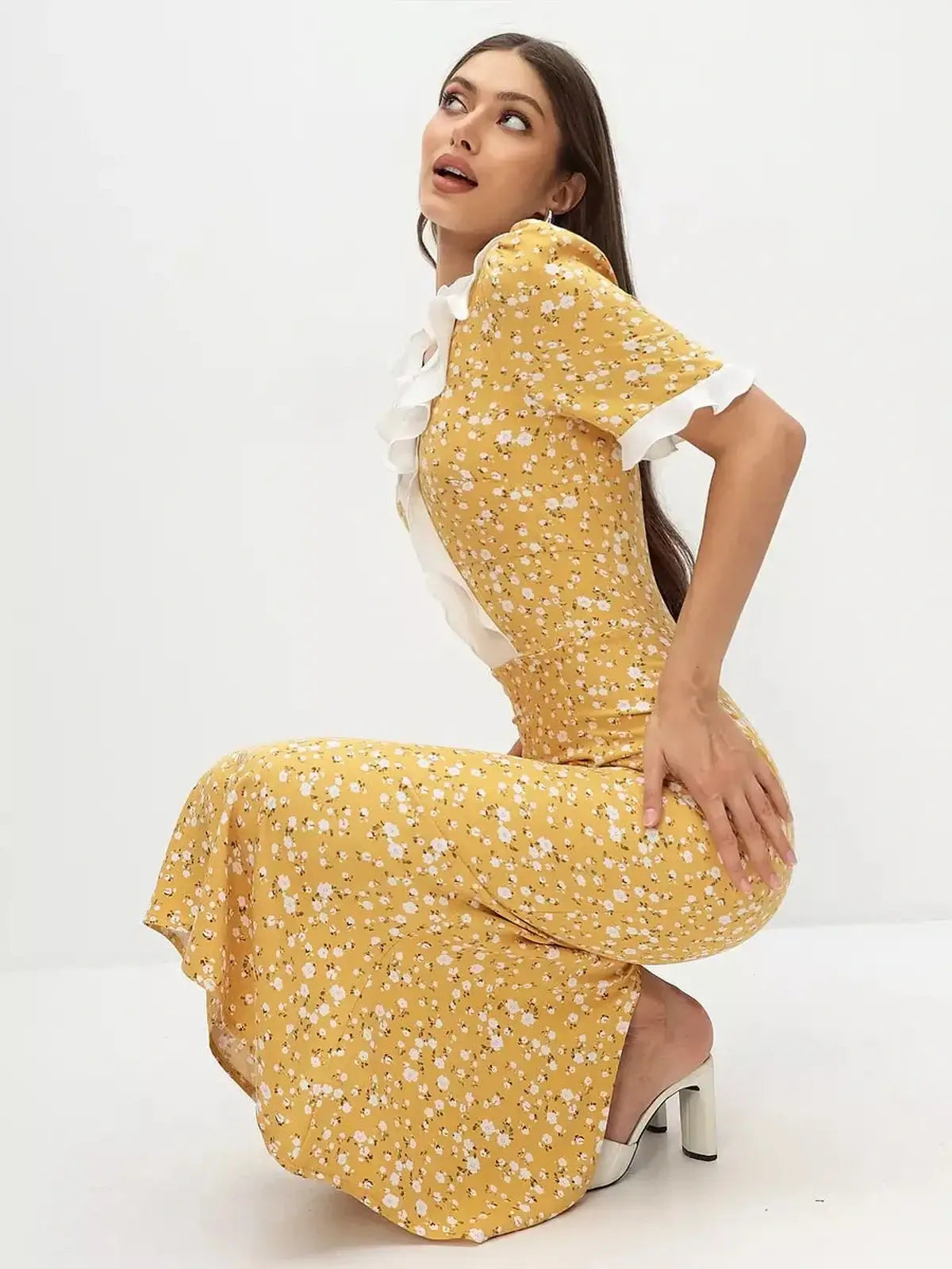 Model showcasing the Golden Muse Midi Dress, a yellow floral design with ruffles and white collar, perfect for summer events.
