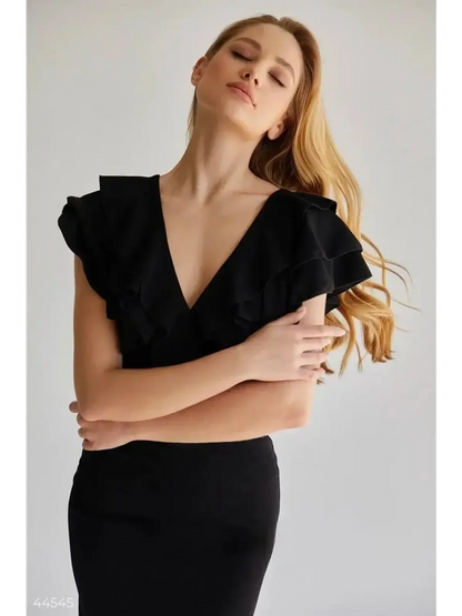 Model wearing a black Ruffle Muse mini dress with layered ruffle sleeves and deep V-neckline, exuding elegance.