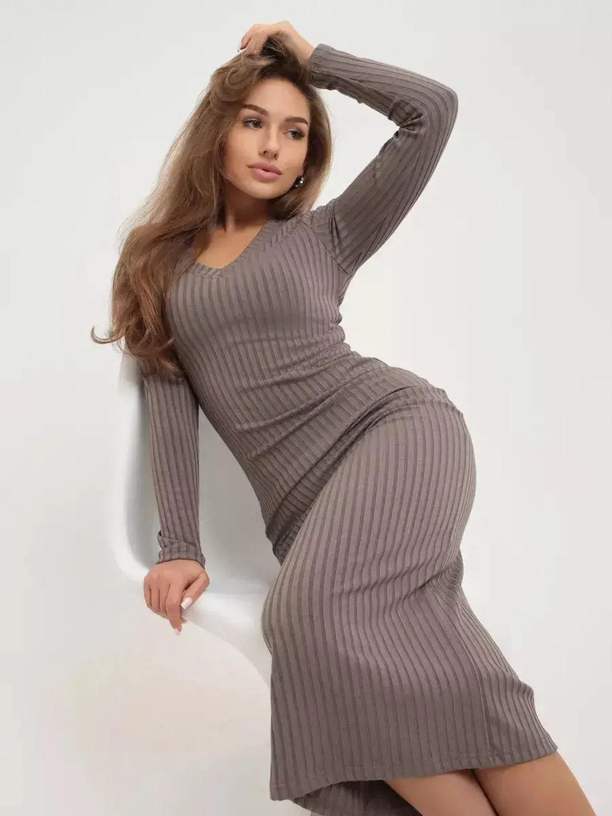 Model wearing a sleek ribbed Contour Midi Dress in taupe, showcasing stylish elegance suited for various occasions.