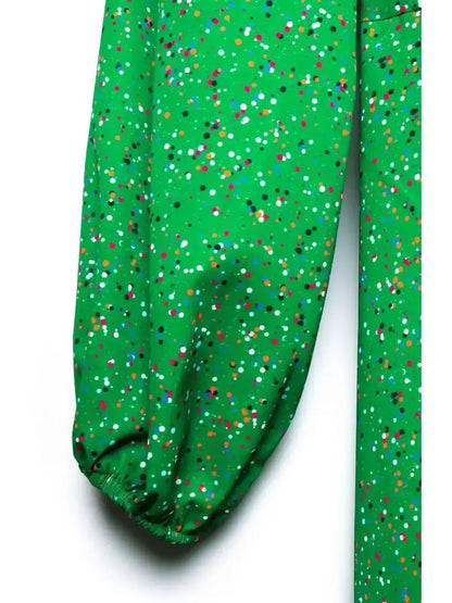 Close-up of vibrant green midi dress fabric featuring colorful speckled dot print, ideal for summer and special occasions.