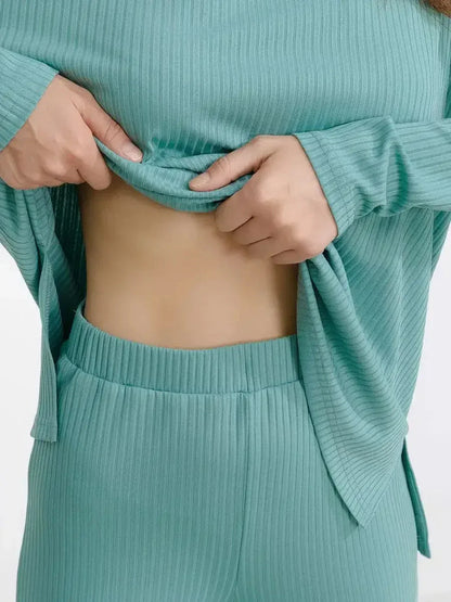 Close-up of a woman adjusting the soft ribbed mint lounge set, showcasing its relaxed fit and comfort.