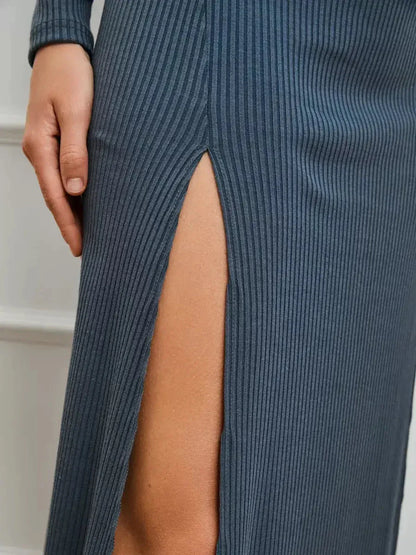 Detail of the Midnight Slit Midi Dress showcasing bold side slit and ribbed knit texture for elegant fashion.