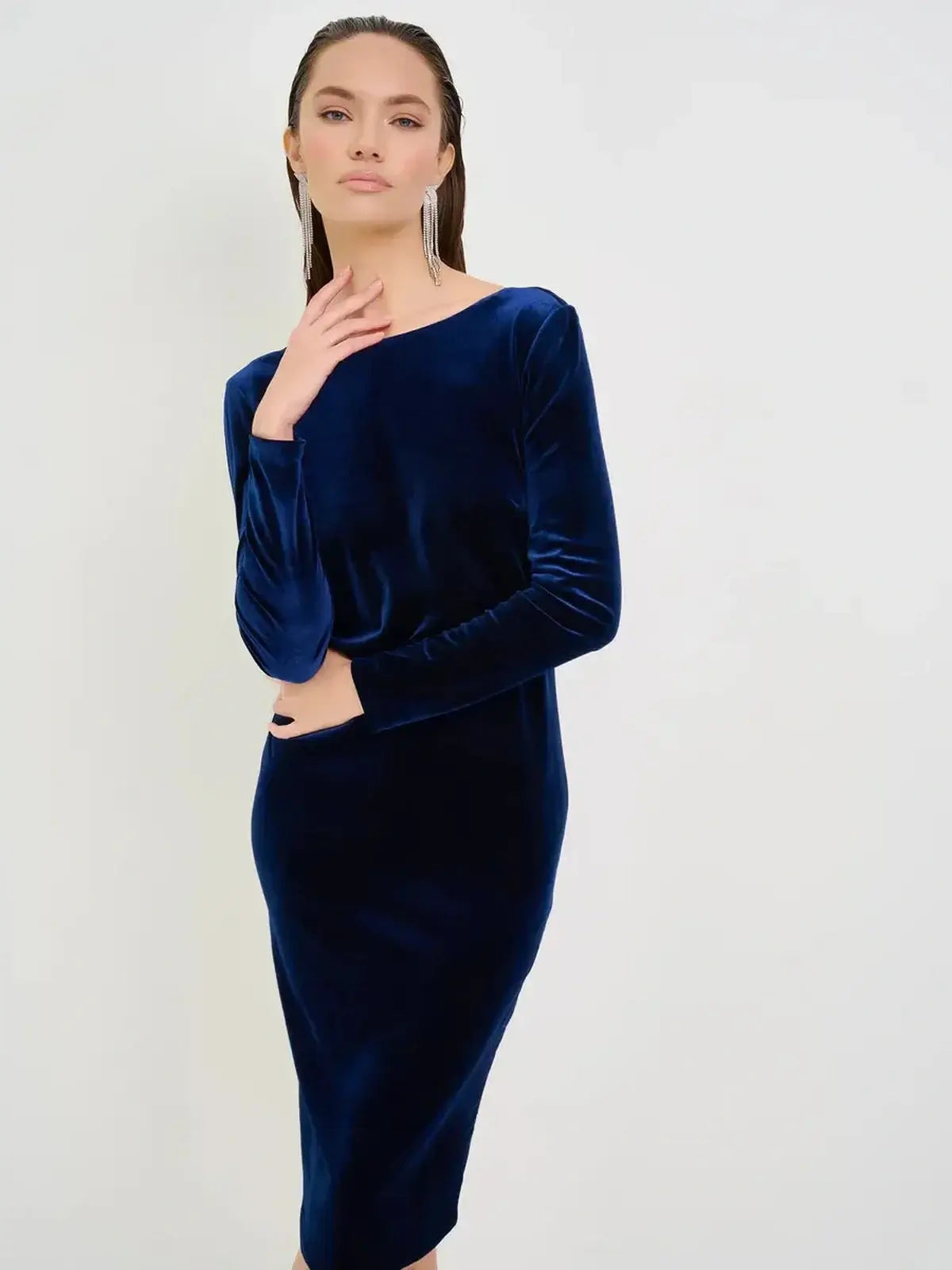 Velvet Obsidian Midi Dress in deep navy, showcasing a sleek silhouette and elegant boat neckline for formal occasions.