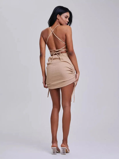 Sahara Strings mini dress featuring a sultry open back and adjustable straps, perfect for summer occasions.