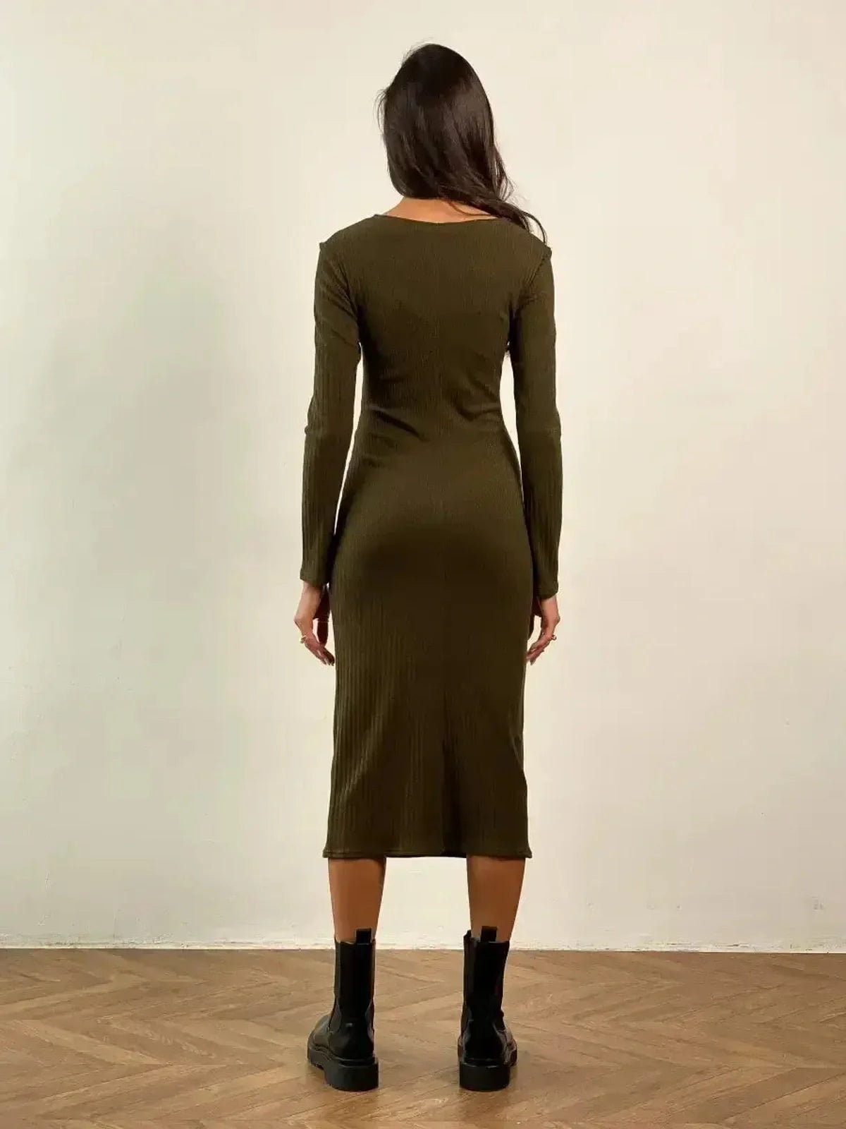 Back view of the Verona Midi Dress in olive green, showcasing its body-skimming ribbed design and long sleeves.