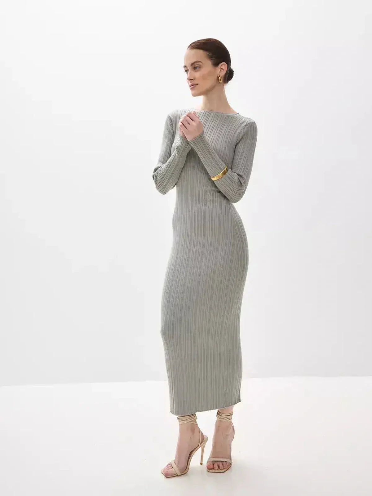 Sculpted Grace Maxi Dress in soft ribbed knit, featuring a sculptural fit and long sleeves for elegant occasions.