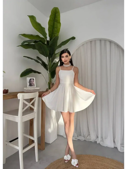 White summer dress featured in a stylish A-line silhouette, perfect for wedding guest dresses and graduation outfits.