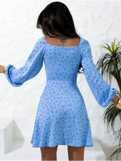 Back view of the Sky Petals mini dress, featuring soft blue fabric with floral prints, perfect for summer occasions.