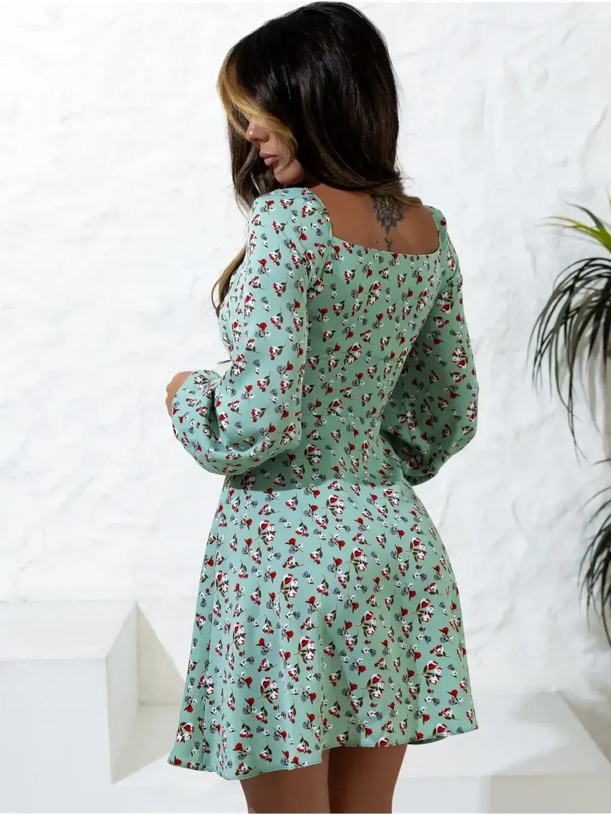 Back view of a light green mini dress with floral print, perfect for summer, weddings, and graduation events.