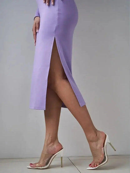 Side view of a woman in a lilac curve midi dress with a thigh-high slit, showcasing elegant and stylish footwear.