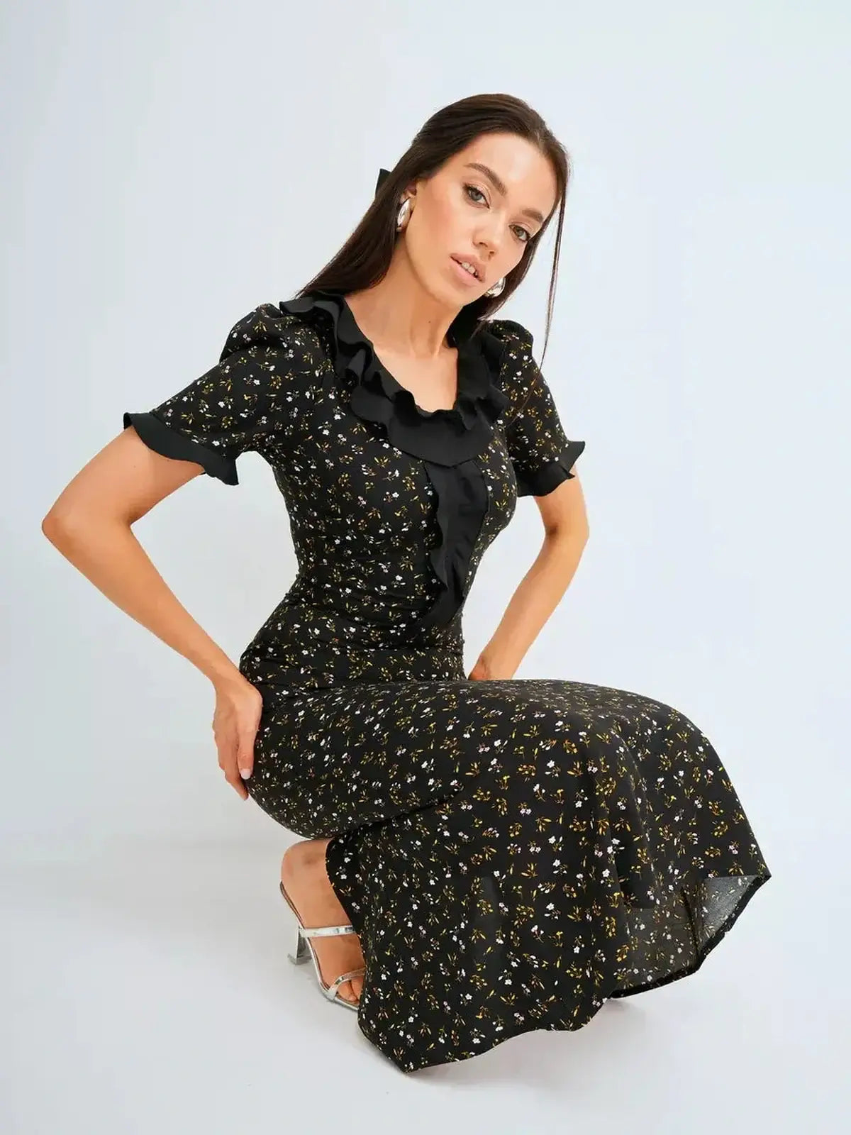 Elegant black midi dress with floral print and ruffles, perfect for weddings, graduations, or formal occasions.