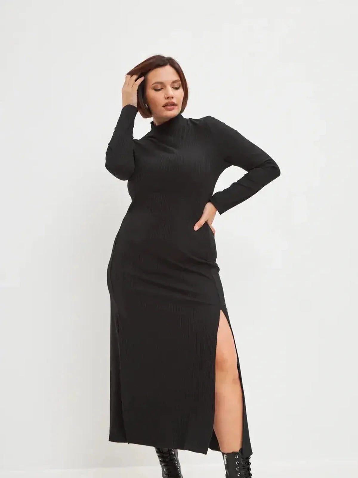 Black midi dress with ribbed texture and dramatic side slit, perfect for modern women styling.