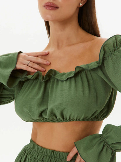 Elegant off-shoulder crop top with gathered ruffle trim in khaki, perfect for summer dresses and wedding guest outfits.