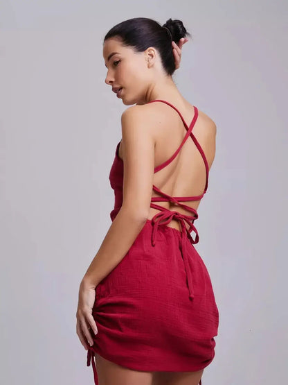 Elegant red mini dress with open back and lace-up detail, perfect for summer events and wedding guest attire.