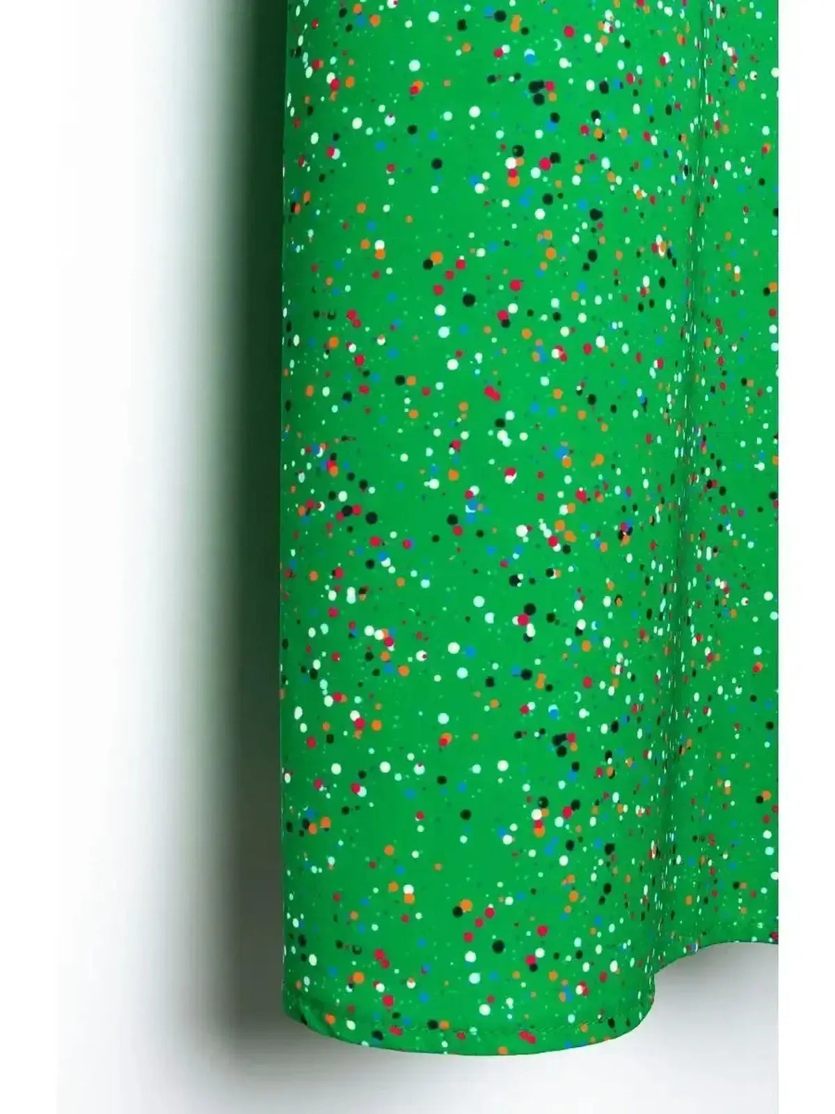 Vibrant green fabric with delicate speckled dot print, ideal for elegant summer dresses and wedding guest attire.