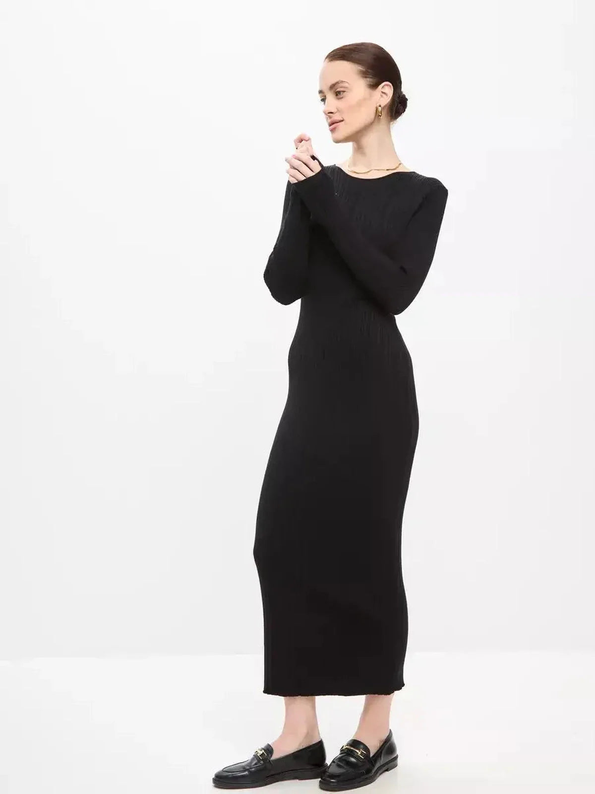 Elegant woman in a black Sculpted Rib Maxi Dress, showcasing a streamlined silhouette and effortless style.