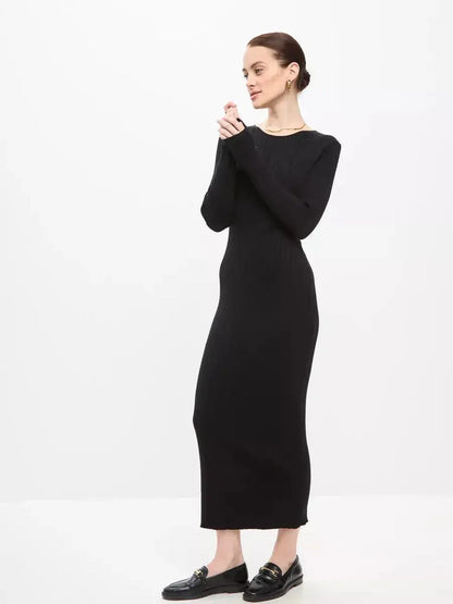 Elegant woman in a black Sculpted Rib Maxi Dress, showcasing a streamlined silhouette and effortless style.