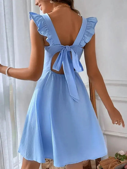 Back view of a sky-blue mini dress with ruffle straps and tie detail, perfect for summer and wedding guest attire.