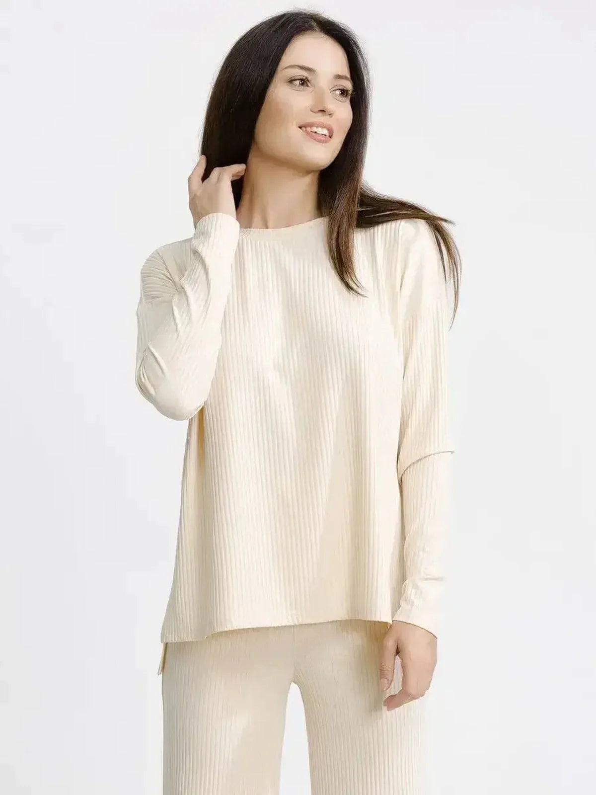 Woman in beige melange soft ribbed lounge set, showcasing casual elegance and comfort for versatile styling.